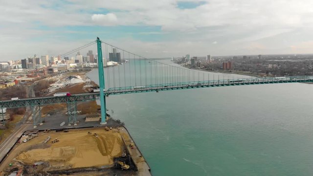 Detroit River Aerial Trucks Crossing Bridge City In Background