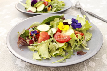 Vegetarian salad with fresh vegetables and flowers.