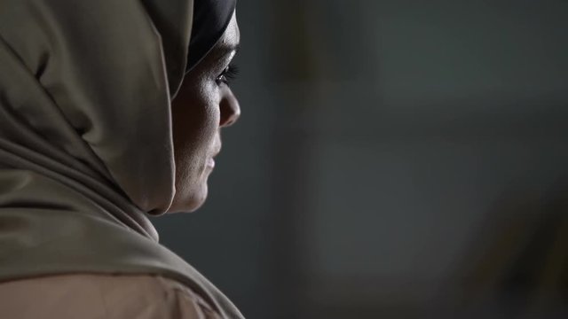 Disappointed muslim woman sighs sadly, cultural limitations, hopelessness crisis