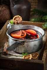 Hot and sweet mulled red wine with cinnamon and oranges