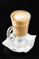 hot cappuccino on the black table