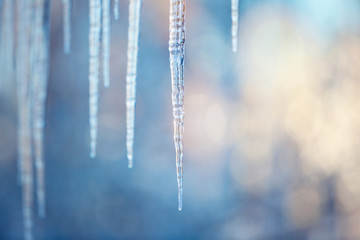 icicles hanging from the edge of the roof - obrazy, fototapety, plakaty