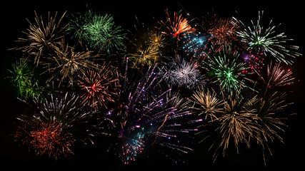 Fototapeta premium Colorful composite of fireworks in vivid colors good as background