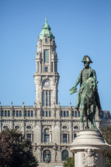 View at the city council building and Dom Pedro IV statue on blurred plan