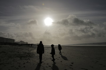 Family with kids and dogs in Normandy beach Le Touquet at winter