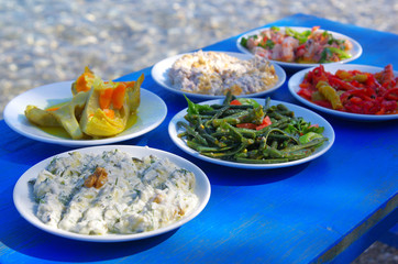 Table of traditional Aegean appetizers at sea side