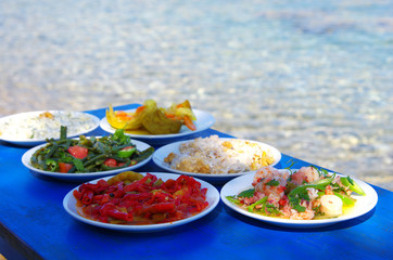 Table of traditional Aegean appetizers at sea side