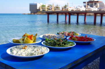 Table of traditional Aegean appetizers at sea side