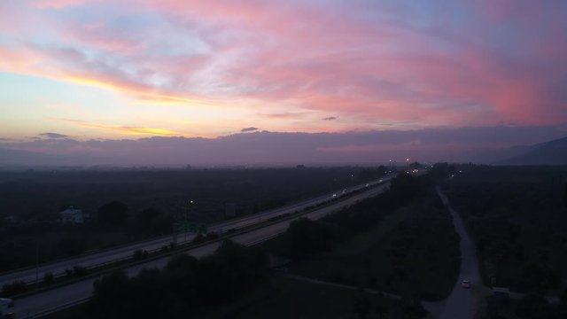 A 4k resoluted footage of a highway with a sunset view