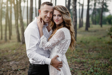 Naklejka premium Happy young couple in love having a good time and embracing in the park.