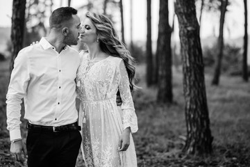 Happy young couple in love having a good time and embracing in the park.