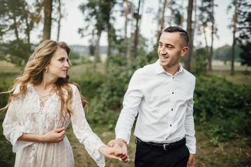 Happy young couple in love having a good time and embracing in the park.