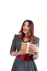 red-haired smiling girl smiles on a gift box