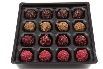 candy box with various color truffles in it