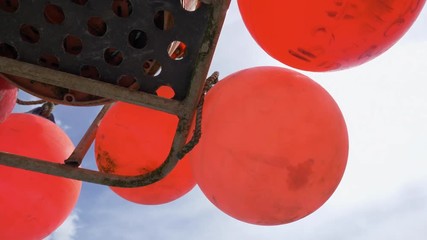 Orange commercial fishing buoys viewed from below.