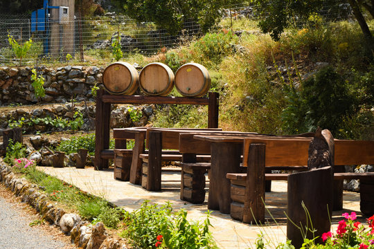 Wooden Barrel Of Wine And Table In Outdoor Cafe. Street Cafes In In Crete, Greece.