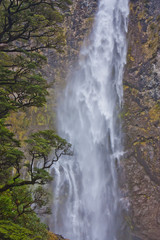 Fototapeta na wymiar Tall large waterfall in Fiordlands in New Zealand
