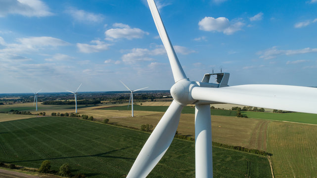 Close-up of Wind Turbine - Windfarm in Horizon