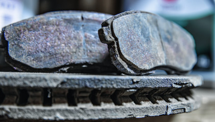 old brake pads on the brake disc with a shallow depth of field