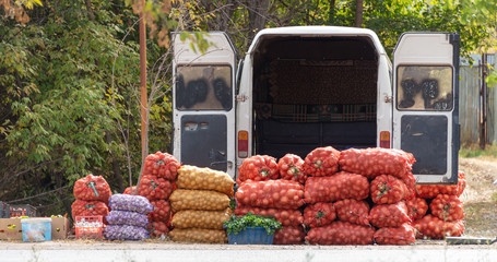 people sell vegetables on a camper right near the highway