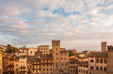 Fototapeta na wymiar Beautiful clouds over Arezzo medieval historic center with old towers st sunset
