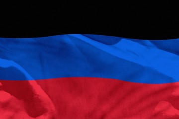 Waving Donetsk Peoples Republic flag for using as texture or background, the flag is fluttering on the wind