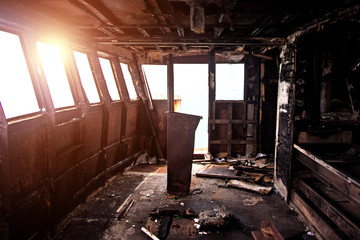 Burnt interior of ship cabin. 