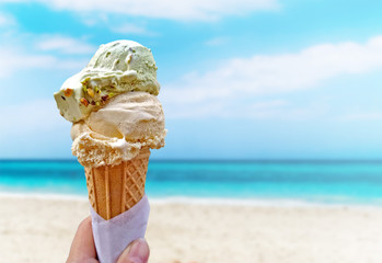 Hand is holding the vanilla ice cream. This is situated in Varadero, Cuba. - Powered by Adobe