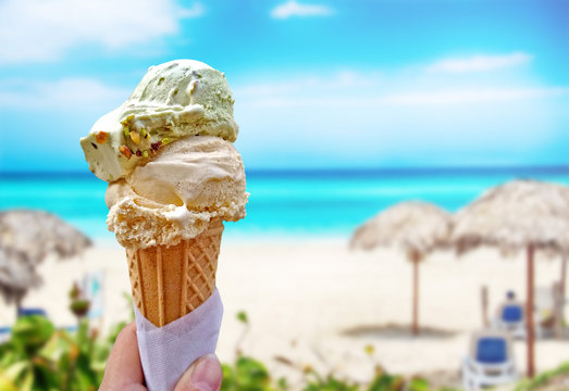 Hand Is Holding The Vanilla Ice Cream. This Is Situated In Tropical Resort In Caribbean.