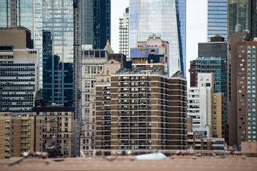 Close-up view of Manhattan skyline seen from the beautiful Brooklyn bridge. Cloudy day in Manhattan, New York City, USA.