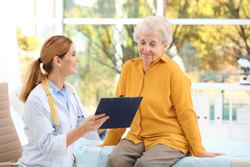 Doctor working with elderly patient in hospital
