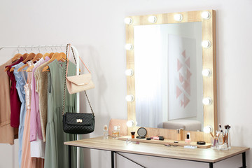 Stylish room with dressing table, mirror and wardrobe rack