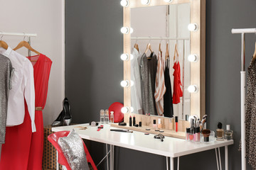 Stylish room with dressing table, mirror and wardrobe rack