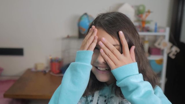 peek a boo. little girl covered her eyes face with her hands hide-and-seek waiting for a surprise. slow motion video. teen girl playing bo-peep. childhood lifestyle concept game hy - spy
