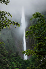 Fototapeta na wymiar Large waterfall in New Zealand on cliff side