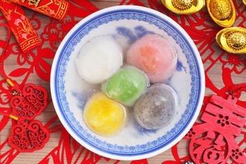 A bowl of Five-flavor glutinous rice balls on the red background  for the Chines Spring Festival 