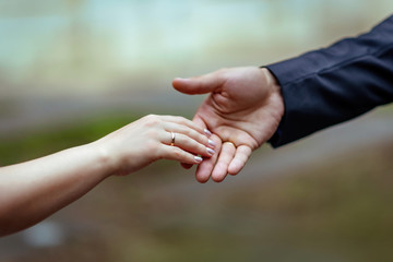 Wedding. Marriage. Hands of the bride and groom with wedding rings. Hand in hand. Love touches. Wedding rings.