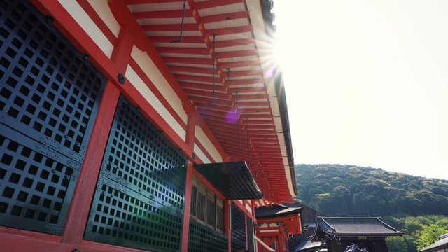 beautiful view along the japanese style temple in japan made of wooden. old history shinto with red roof black window on sunny day in summer shrines in background. Kiyomizu dera pagoda in kyoto.