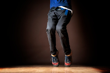 legs of male dancer on dark background b