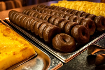 Buffet of donuts and pancakes for dessert in an unhealthy restaurant.