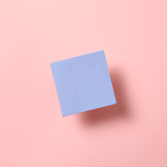 Fototapeta na wymiar Blue memo pad, sticky note on pink background