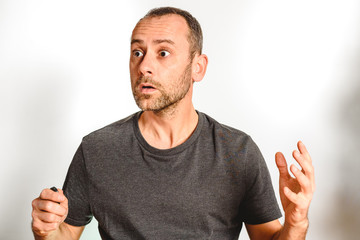 Man in studio overwhelmed, stressed and surprised, model expressions isolating white background