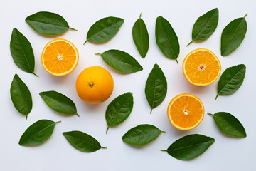 Oranges with green leaves on white