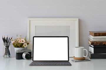 Mockup blank screen modern tablet on hipster workspace