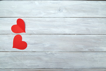 Red paper hearts on white wood Valentine's Day