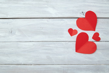 Red paper hearts on white wood Valentine's Day