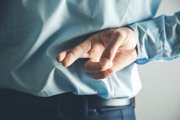 man finger cross in back