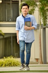 Fototapeta premium Smart University Asian Boy Student With Books Walking On Campus