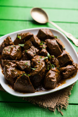 Mutton Liver fry or Kaleji masala, popular Non vegetarian recipe from India and Pakistan. served dry or with curry in a bowl, karahi or plate