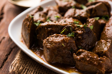 Mutton Liver fry or Kaleji masala, popular Non vegetarian recipe from India and Pakistan. served dry or with curry in a bowl, karahi or plate